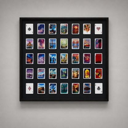 Framed display of playing cards with various designs on a gray wall.