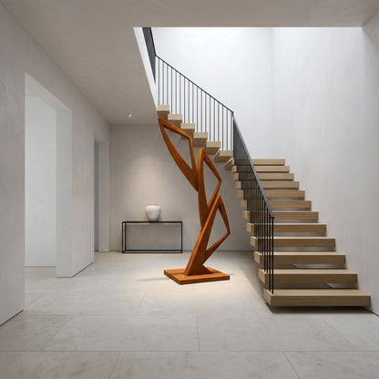 Modern staircase with wooden sculpture in a minimalistic interior