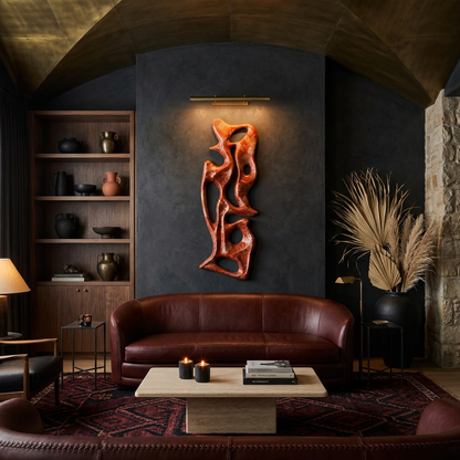 Living room with a brown leather sofa, wooden coffee table, and decorative wall art.